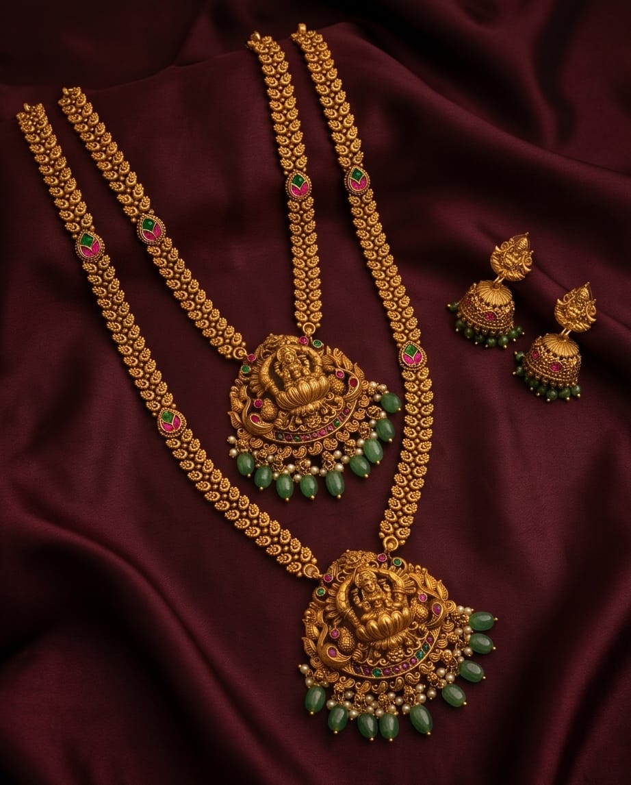 Gold necklace with green beads and matching earrings on a dark fabric background
