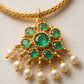 Gold necklace with emerald and pearl pendant on a light background