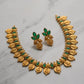 Gold and green jewelry set on a marble surface