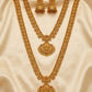 Gold necklace and earrings set on a beige fabric background