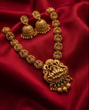 Gold necklace and earrings on a red fabric background