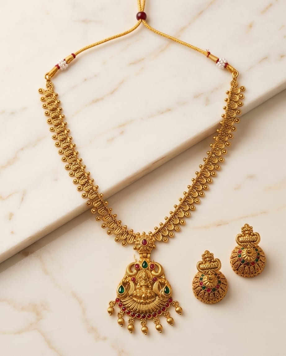 Gold necklace and earrings on a marble surface